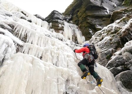 مردی درحال بالا رفتن از “کیندر داونفال” یخ زده